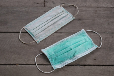 used surgical mask on the floor. discarded mask concept corona virus,covid-19.の写真素材
