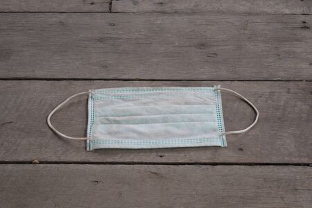 used surgical mask on the floor. discarded mask concept corona virus,covid-19.の写真素材