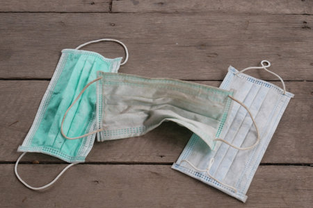 used surgical mask on the floor. discarded mask concept corona virus,covid-19.