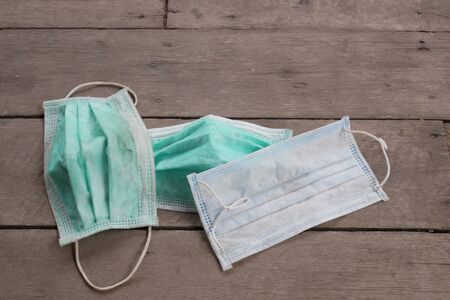 used surgical mask on the floor. discarded mask concept corona virus,covid-19.の写真素材
