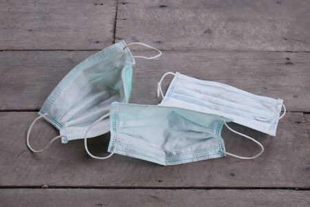 used surgical mask on the floor. discarded mask concept corona virus,covid-19.の写真素材