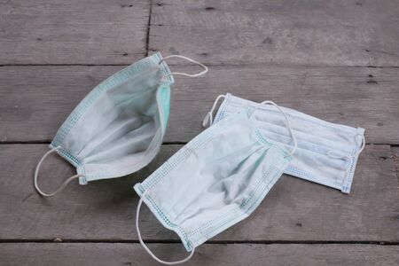 used surgical mask on the floor. discarded mask concept corona virus,covid-19.の写真素材