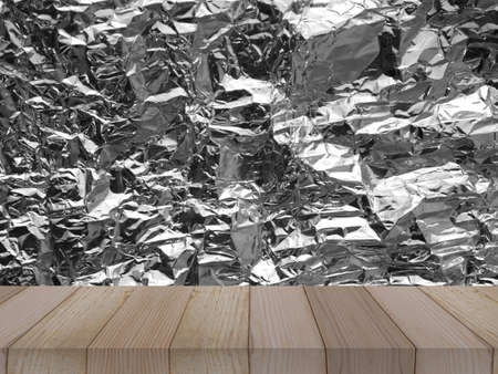 wood table on aluminium foil texture background for product display, metal plateの写真素材