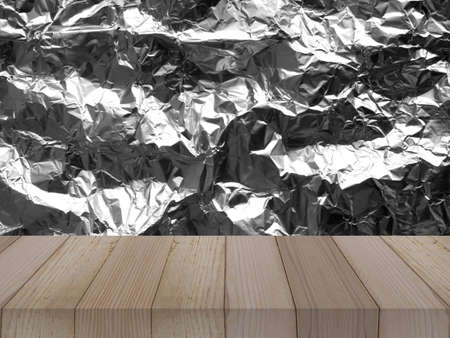 wood table on aluminium foil texture background for product display, metal plateの写真素材