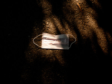 used surgical mask on the floor. discarded mask concept corona virus,covid-19.