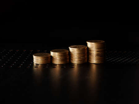 stacks of gold coin on black background concept saving moneyの写真素材