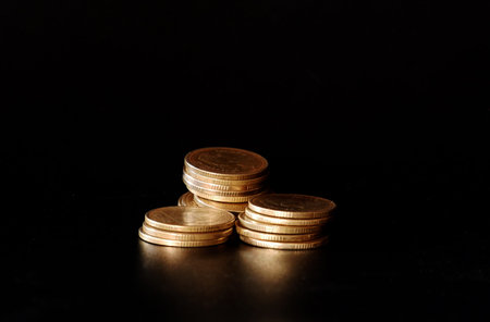 stacks of gold coin on black background concept saving money
