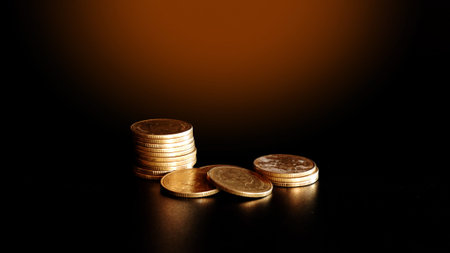 stacks of gold coin on black background concept saving money