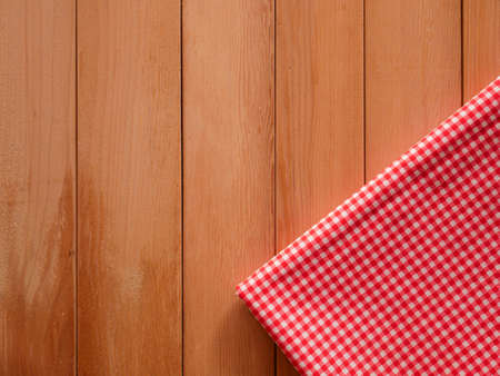 Classic pink plaid fabric or tablecloth on wood desk with copy spaceの写真素材