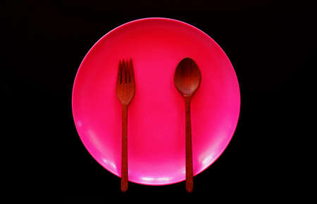 Empty plate with spoon and fork on tableの写真素材