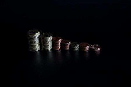 stacks of coin on black background concept save money