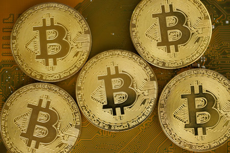 Close up of gold bitcoin on blur background with selective focus