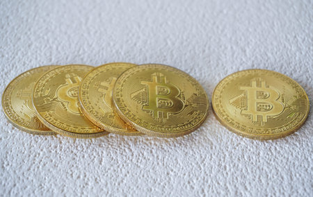 Close up of gold bitcoin on blur background with selective focus