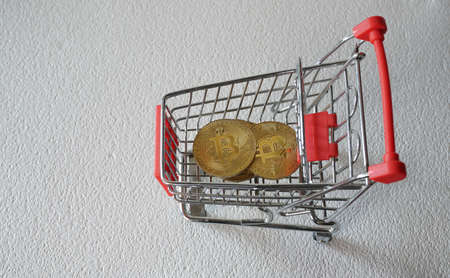 bitcoin in shopping cart on white backgroundの写真素材
