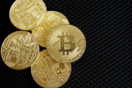 Golden bitcoin digital money on black background with copy space