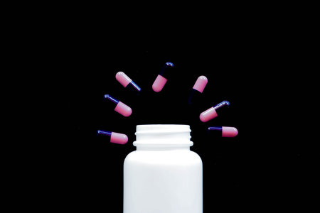 medical pills on black background, bottle of pills concept virus fever