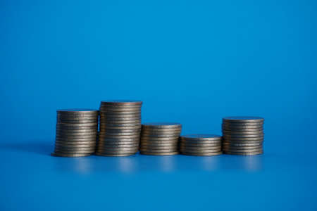gold stack coins money on blue backgroundの写真素材