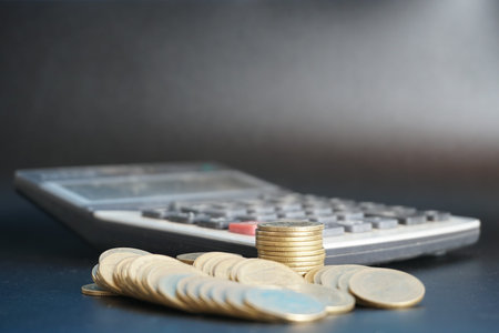 stacks of money coin with calculator, Business and financial investment concept blur background