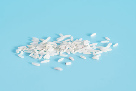 Organic raw rice on blue background