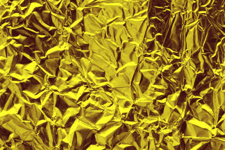 Shiny yellow gold foil abstract texture backgroundの写真素材