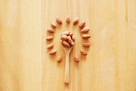 Almonds seed isolated background. almond on wood tableの写真素材