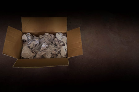 Opened cardboard box on concrete floor