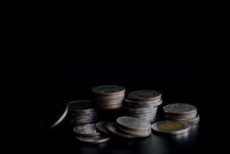 Coins stack on black background with copy space, business and finance concept.の写真素材