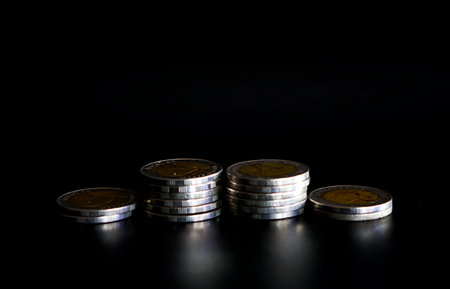 Coins on a black background. Close-up. Selective focus.の写真素材