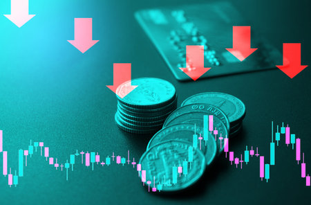 Stack of silver coins with red down arrow graph on green background.