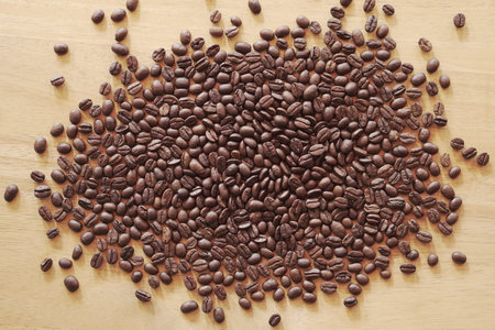 Coffee beans on wooden background. Top view, flat lay
