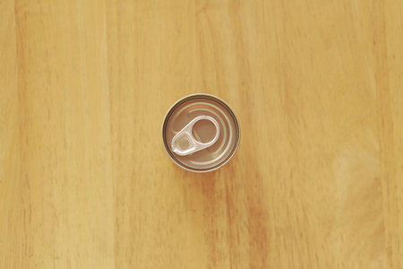 Top view of aluminum can on wood background, can be used as backgroundの写真素材