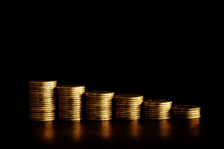 Golden coins stacks on black background, business and finance concept idea.の写真素材