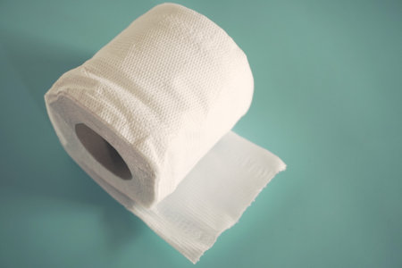 toilet paper roll on turquoise background with copy space.の写真素材