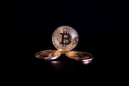 Golden bitcoin on black background. Cryptocurrency concept. Close up.の写真素材