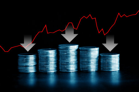 Stacks of coins with red arrow graph on black background, business and finance concept idea.