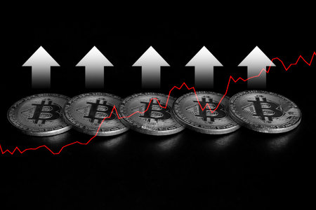 Silver bitcoins and red arrow on black background. 3D illustration.の写真素材