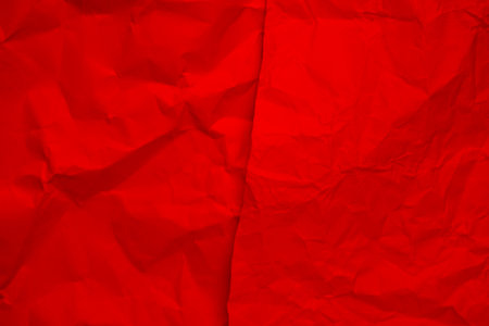 Red creased crumpled paper background grunge texture backdrop.の写真素材