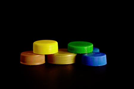 Plastic bottle caps isolated on black background, copy space for textの写真素材
