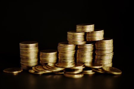 Stacks of gold coins on black background, business and finance concept idea.の写真素材