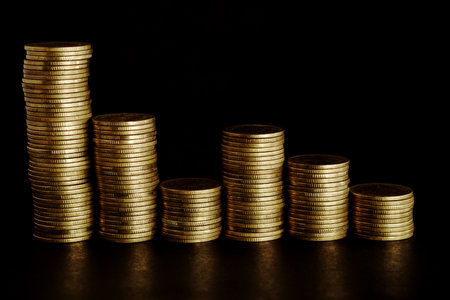 Stacks of gold coins on black background, business and financial concept.の写真素材