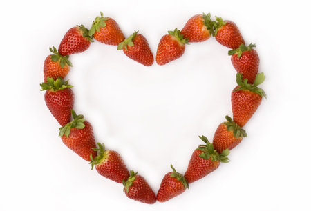 Strawberries heart on white backgroundの写真素材