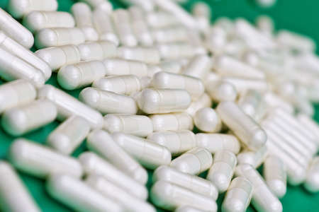 Close up of capsules on green backgroundの写真素材