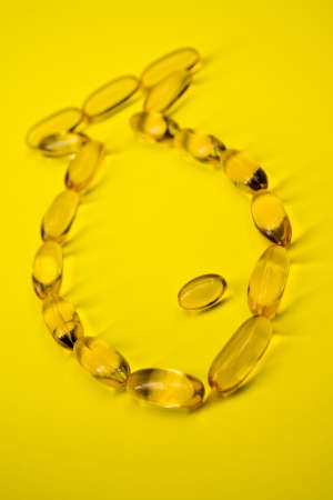 Cod liver fish oil capsules shaped as a fishの写真素材