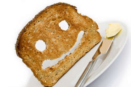 Smiley made from toasted bread with knife plate and butterの写真素材