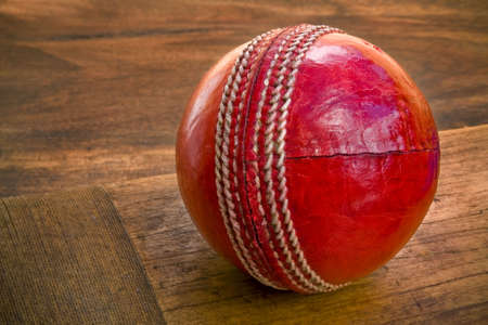Close up of cricket ball on wooden batの写真素材