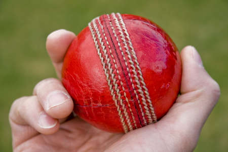 Cricket bowlers hand with ball about to bowlの写真素材