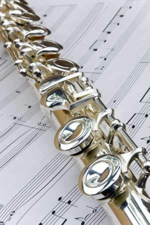Flute lay diagonally across sheet music notes の写真素材