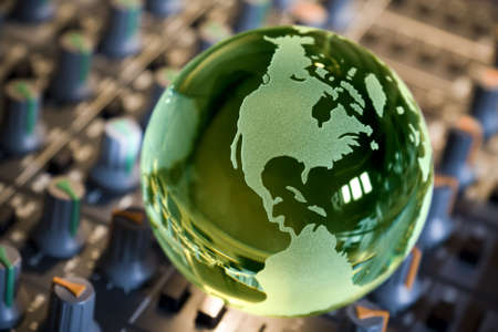 World music concept, globe on mixing consoleの写真素材