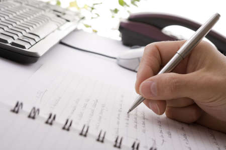 Businessman taking notes and planning in a meetingの写真素材