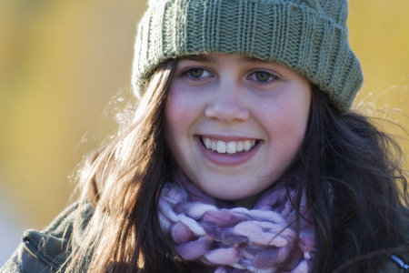 Smiling girl on a cold sunny day outdoorsの写真素材